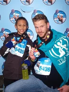 Uncle D and Jaylen showing their medals Disney and TSA 5K Run 2010